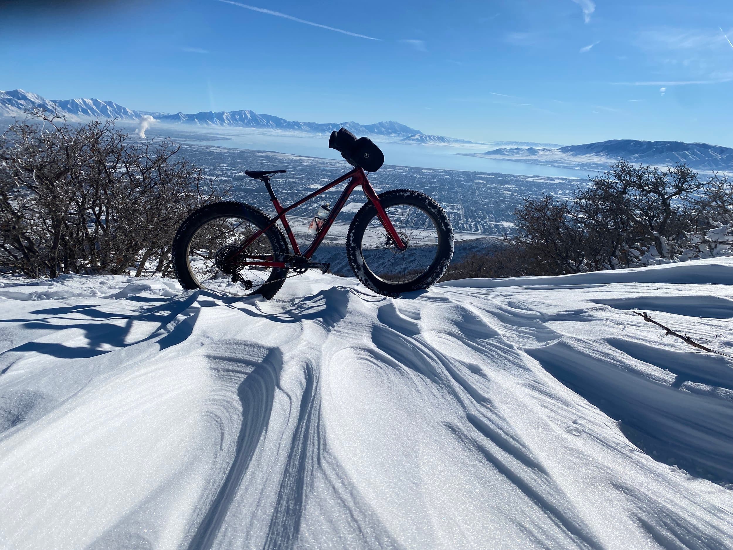 Fat bike parked in wind-carved snow above the Salt Lake valley