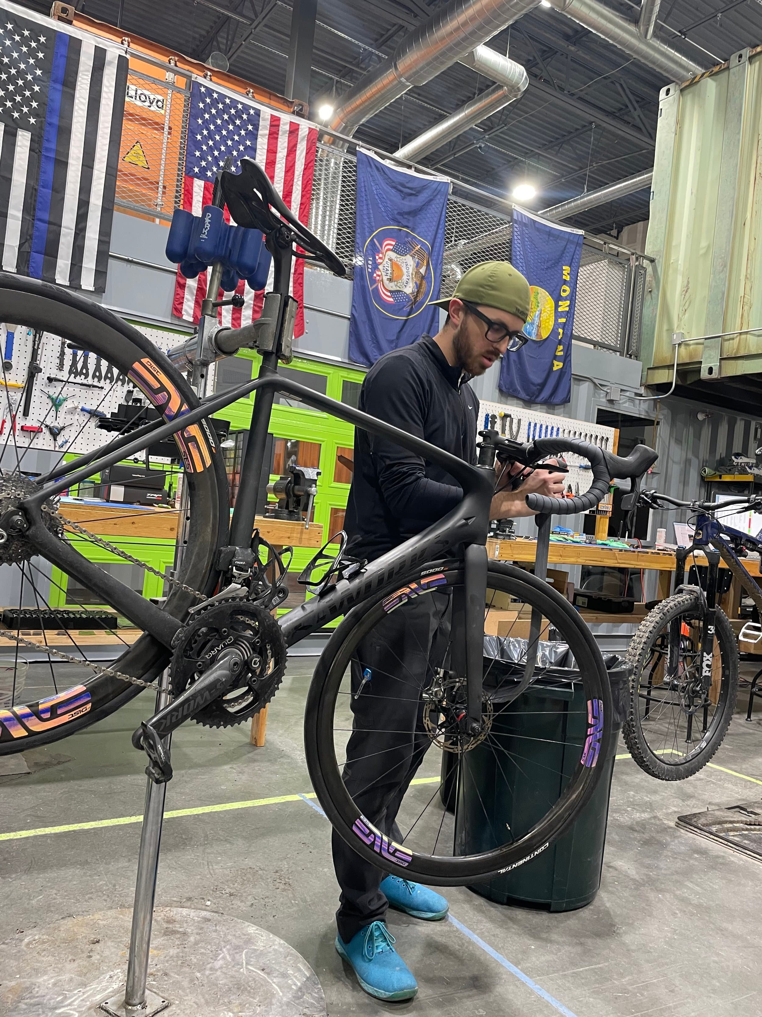 Jamen working on a road bike in the LegUp Cycle Works shop
